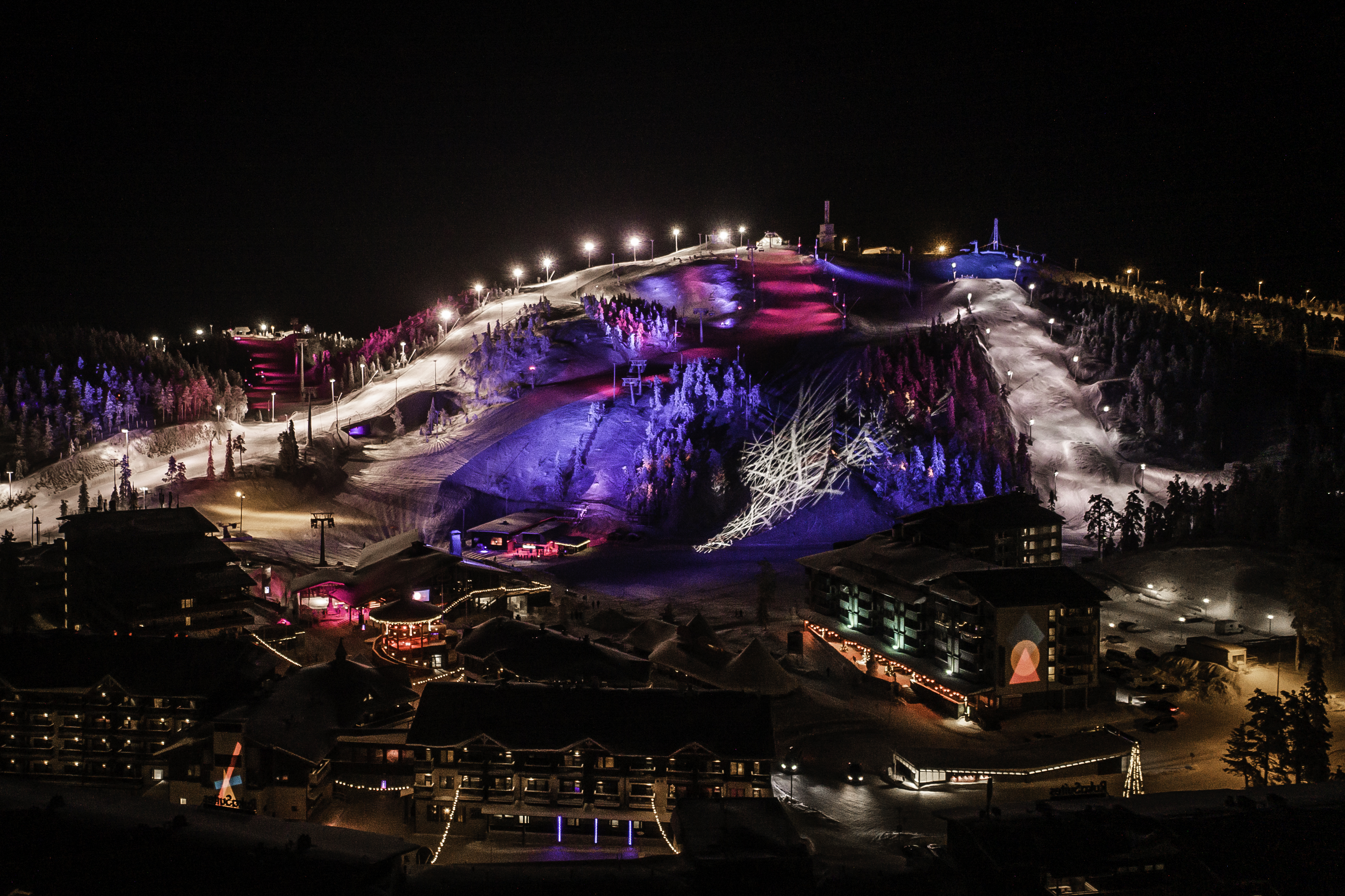 Skiing amidst colored lights at the Polar Night Light Festival